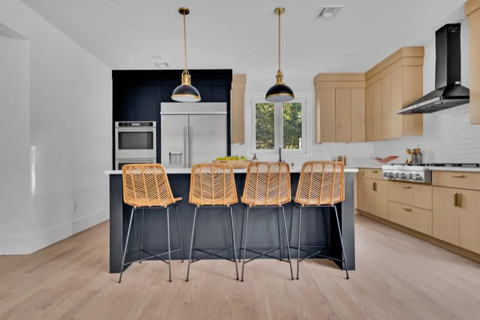 Kitchen with navy island and white oak cabinetry